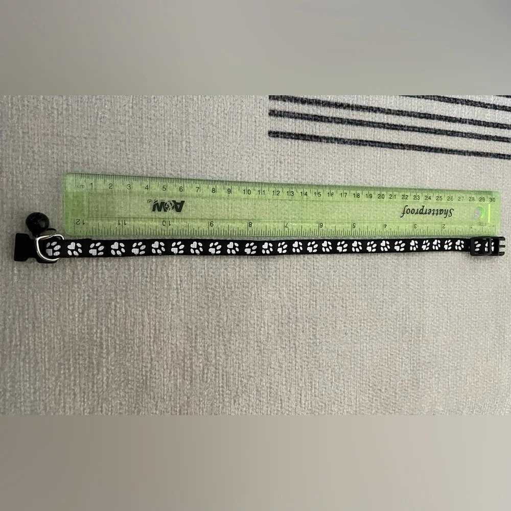Collar with White Paw Print Pattern and Matching Bell and Buckle